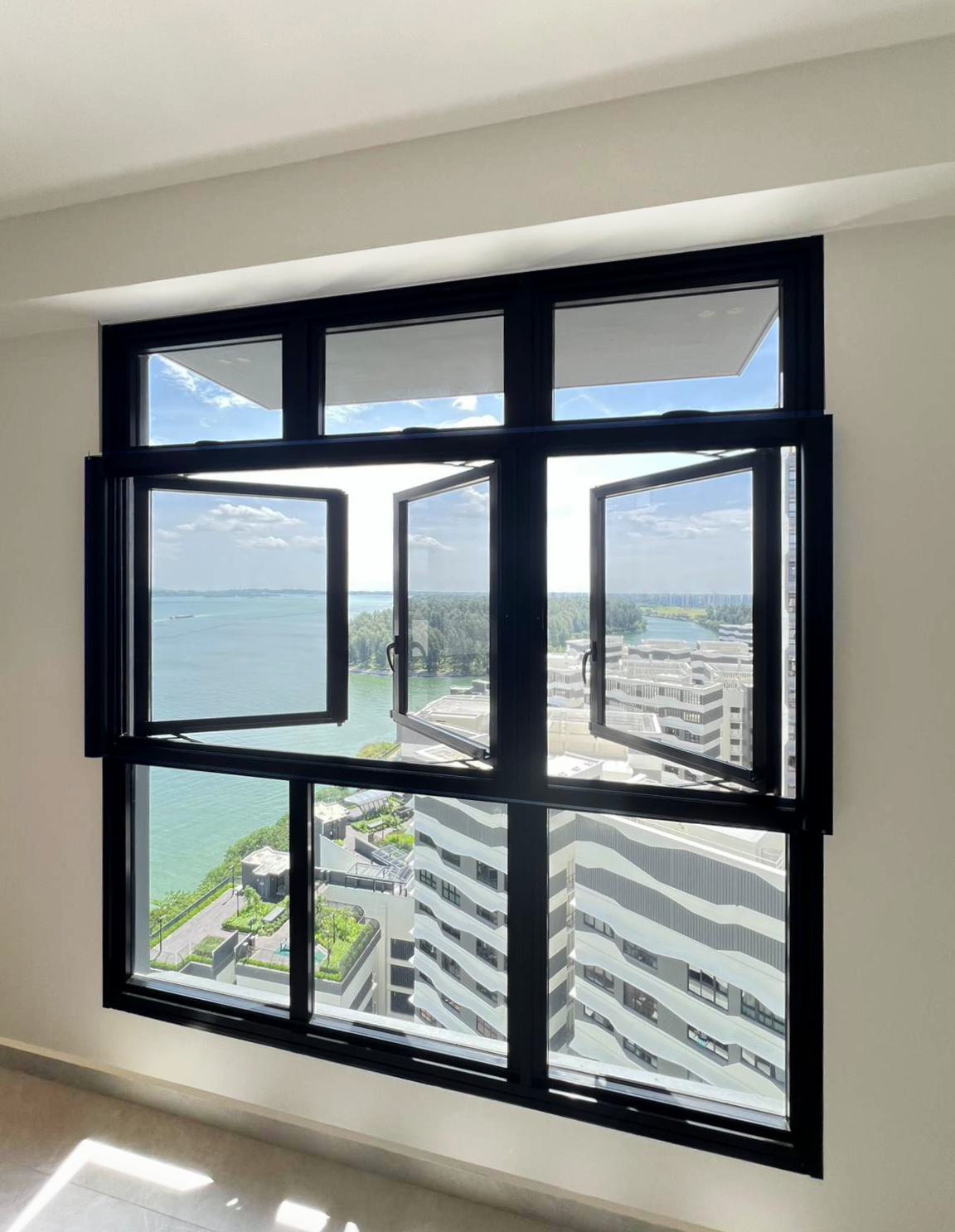 Retractable insect screen installed on a modern window overlooking water and buildings at Northshore BTO, Singapore