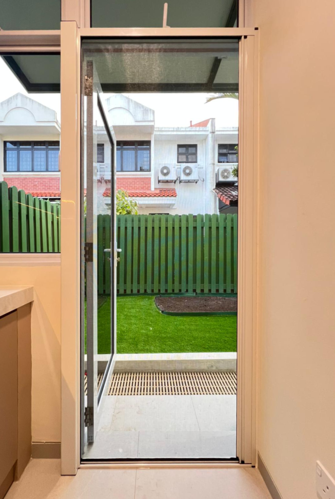 Retractable door mesh installed on a single swing door leading to backyard for insect protection
